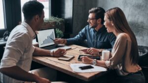 Three people looking at a report for better insight into your bookings