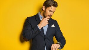 A handsome man looking at his watch waiting for a no-show or cancellation for salon appointment scheduling