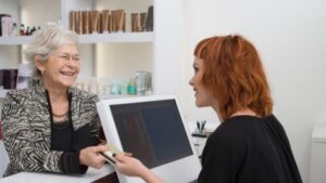 A happy client being served by a hairdresser