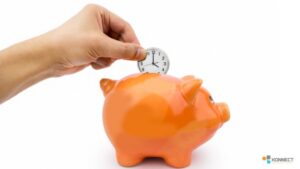 An orange piggy bank with a hand putting in a clock