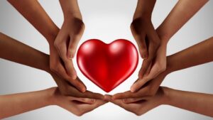 Hands around a heart signifying charity