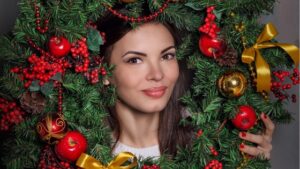A woman looking through a christmas wreath